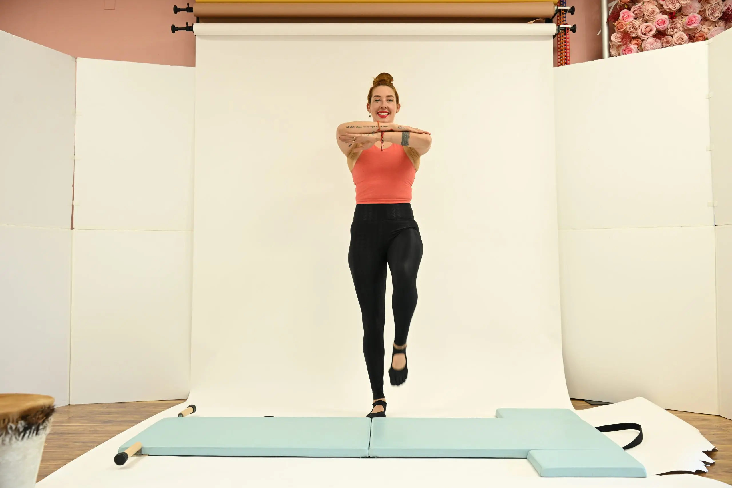 lesley logan demonstrating pilates for travel wall exercises to improve posture at an airport
woman performing wall Pilates moves like wall hundred and wall squats for better posture while traveling
traveler doing quick movement snacks and stretches at a train station to relieve back pain
online pilates classes app interface for finding travel-friendly mat classes and workouts